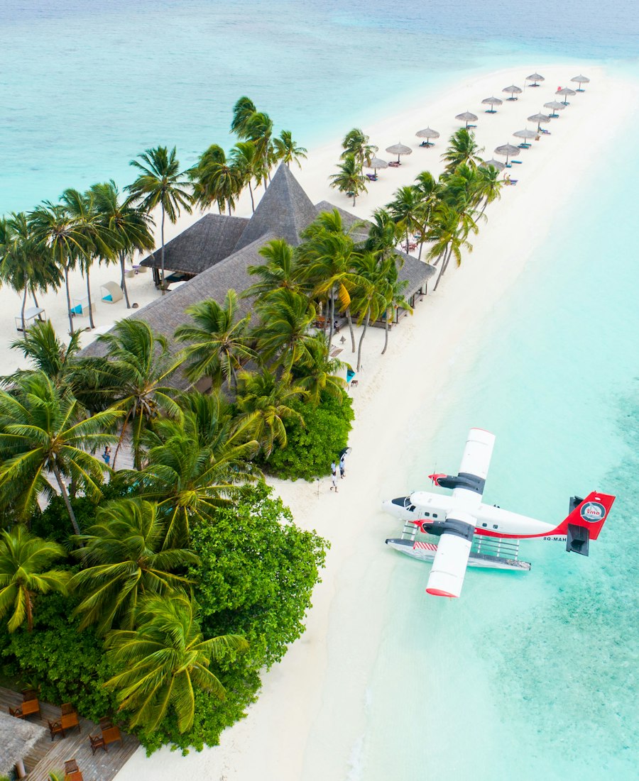 Seaplane parked on a white sand beach