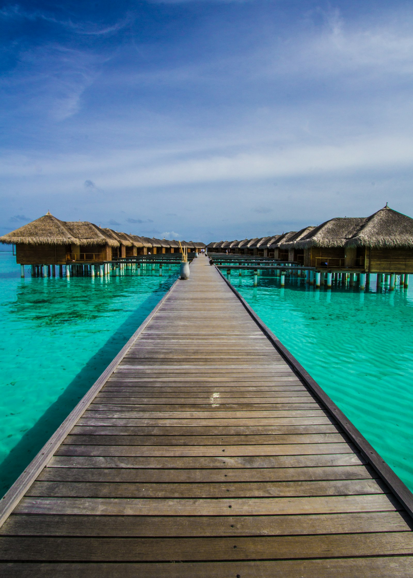 Wooden pier leading to overwater villas in the Maldives