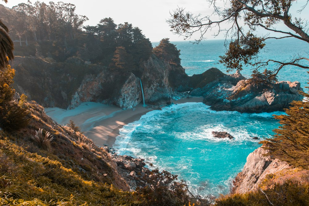 Waterfall falling onto a cove on the Big Sur coast