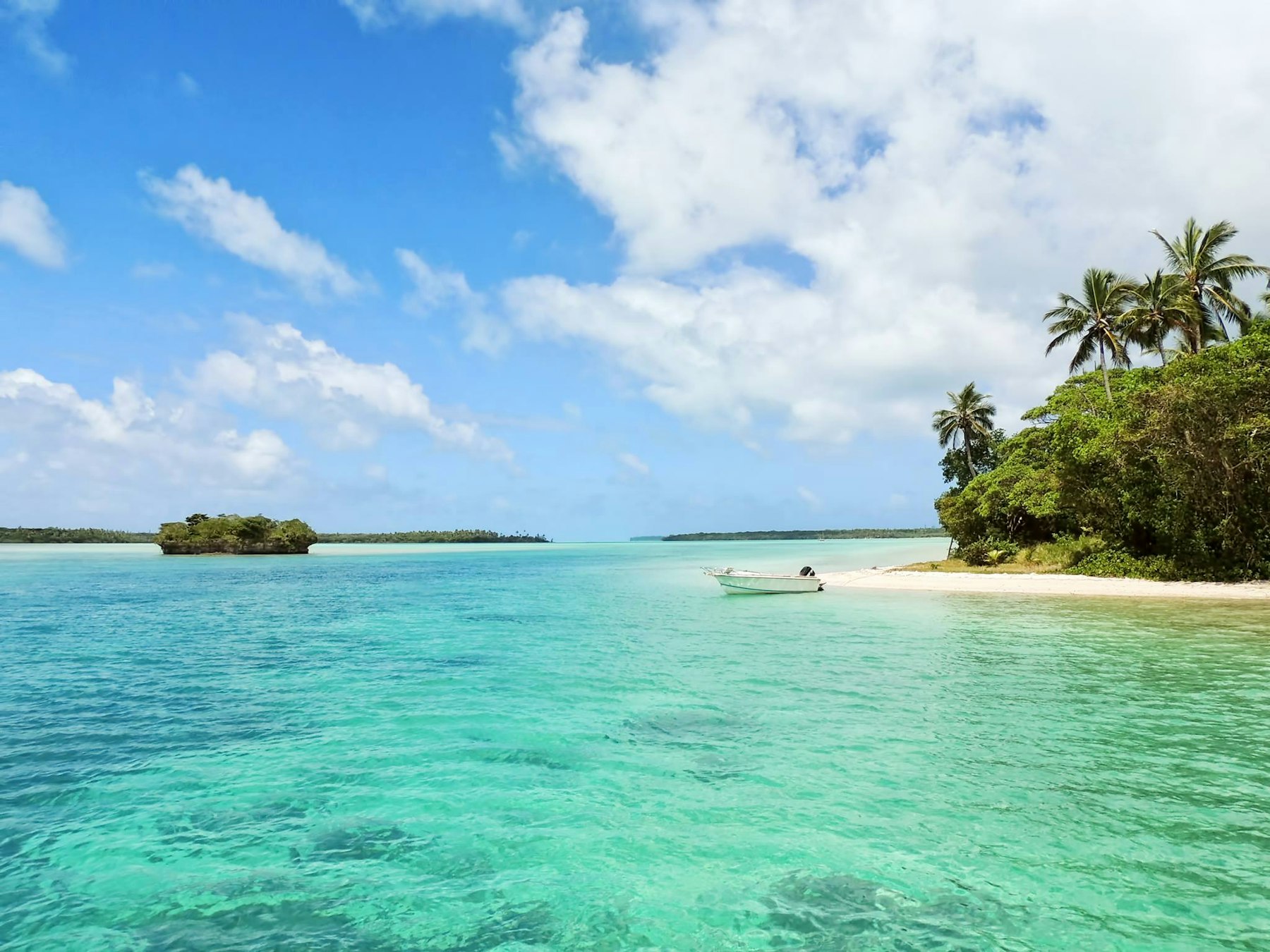 Turquoise water and palm-covered islands in the Seychelles